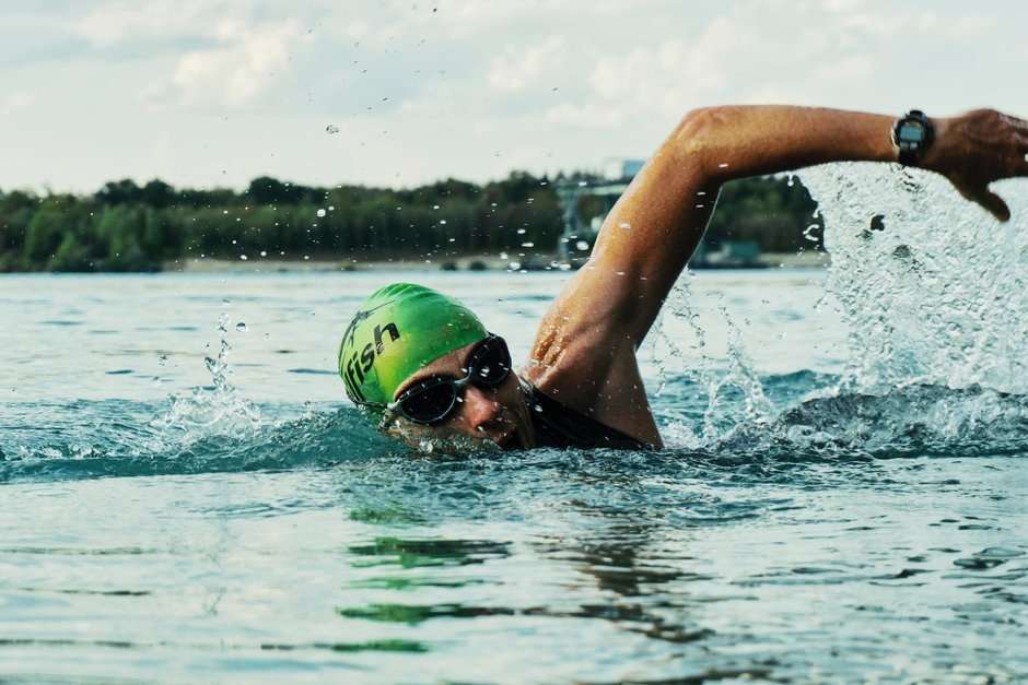 Person Swimming Across a Lake