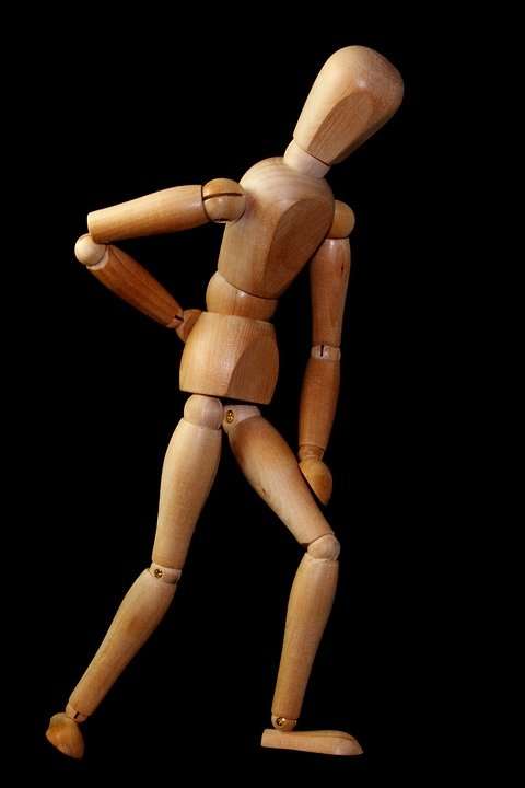 Wooden figure depicting back pain